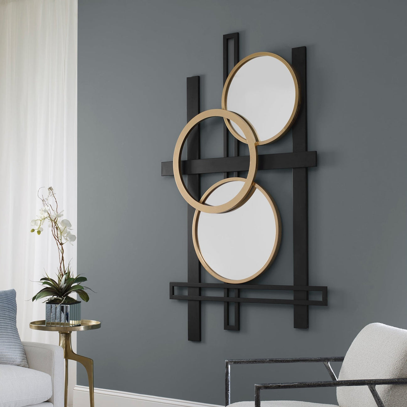 Elegant accent wall décor featuring modern artwork and decorative mirrors for a stylish interior.