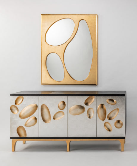 Cabinet with abstract stone design and gold-framed mirror on a light gray background