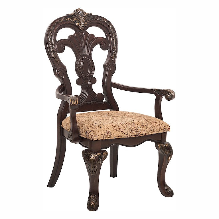 Decorative wooden chair with intricate carvings and a patterned cushion on a white background