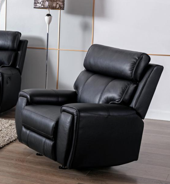 Black leather recliner chair in a living room setting with a lamp and rug.