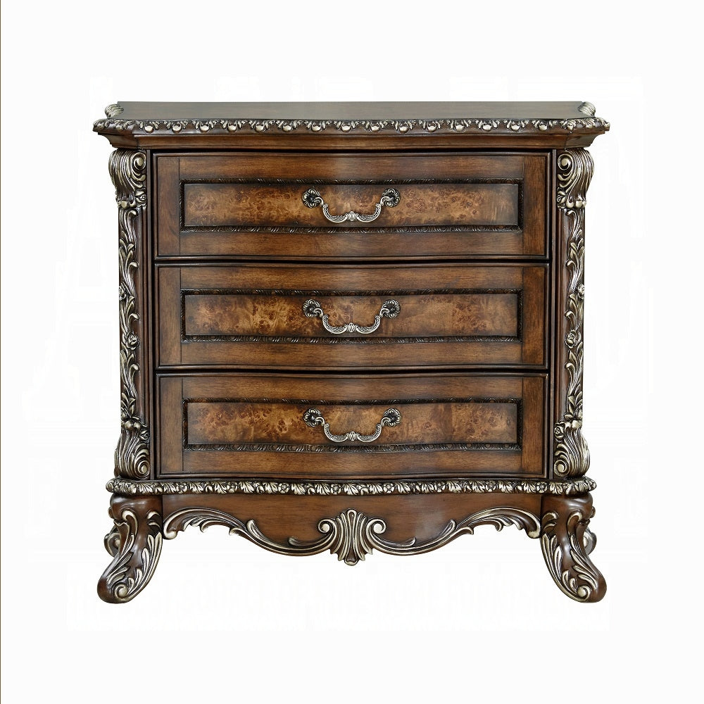 Decorative wooden chest of drawers with intricate carvings on a white background