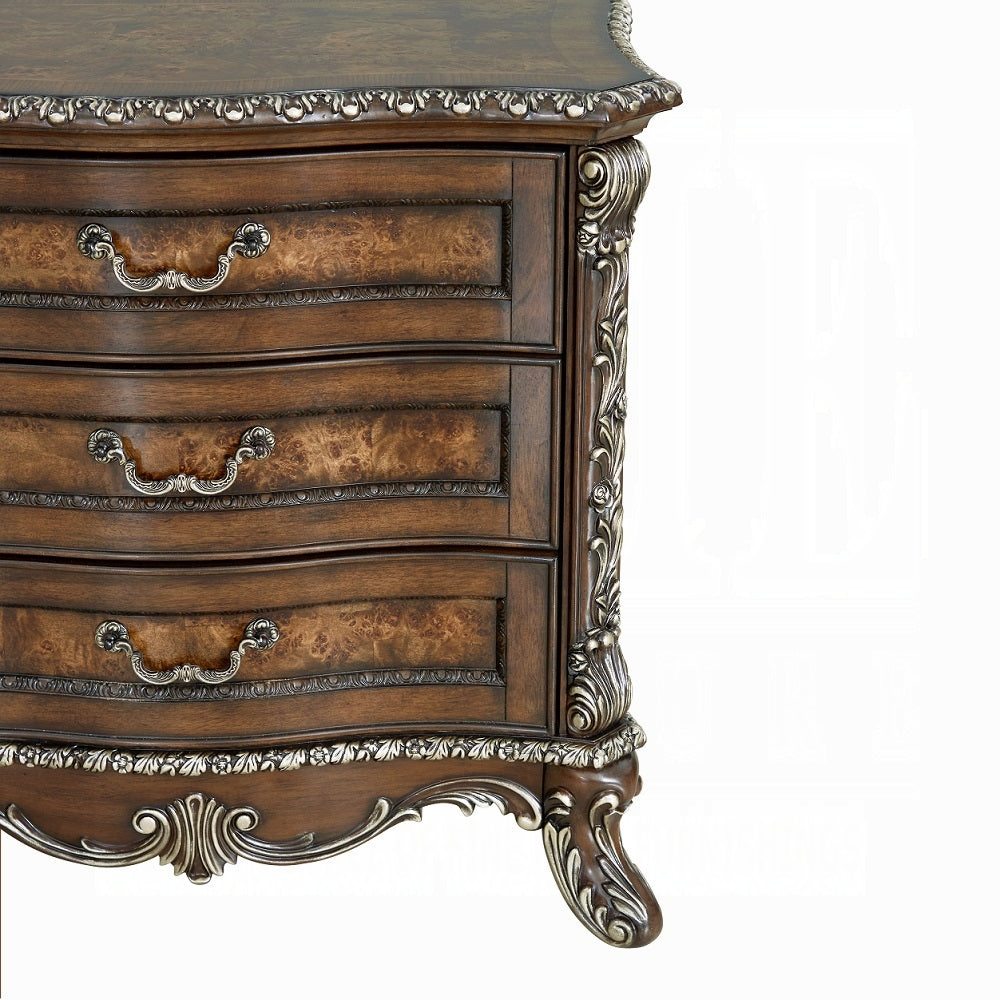 Decorative wooden dresser with intricate carvings on a white background