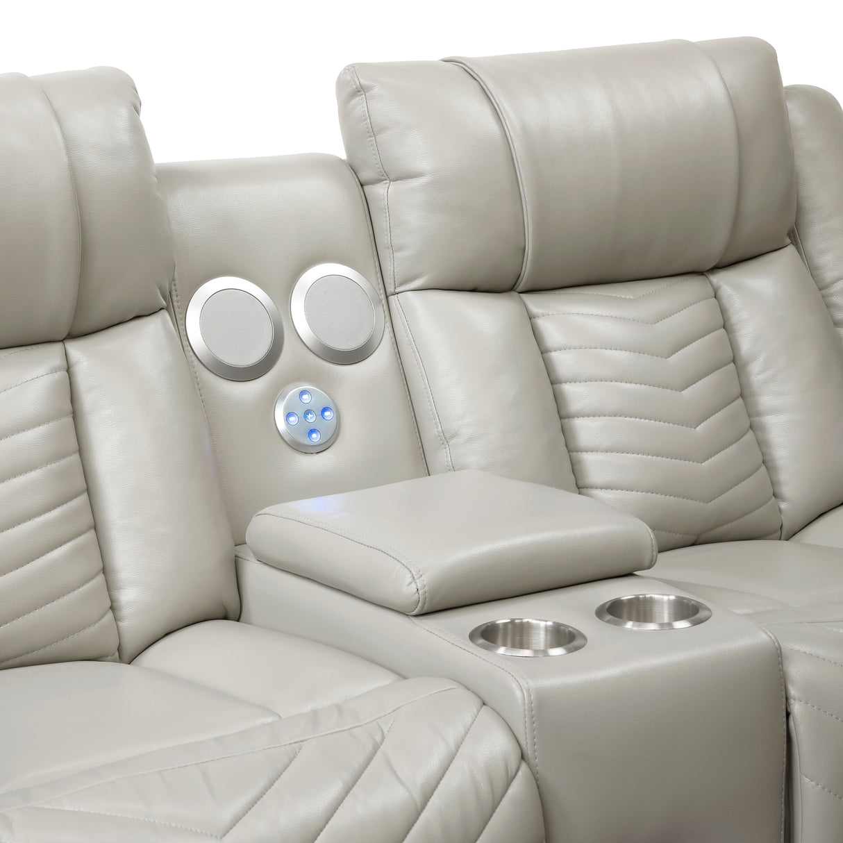 Drop-down center console with stainless steel cup holders, hidden storage, and wireless speakers on gray power loveseat
