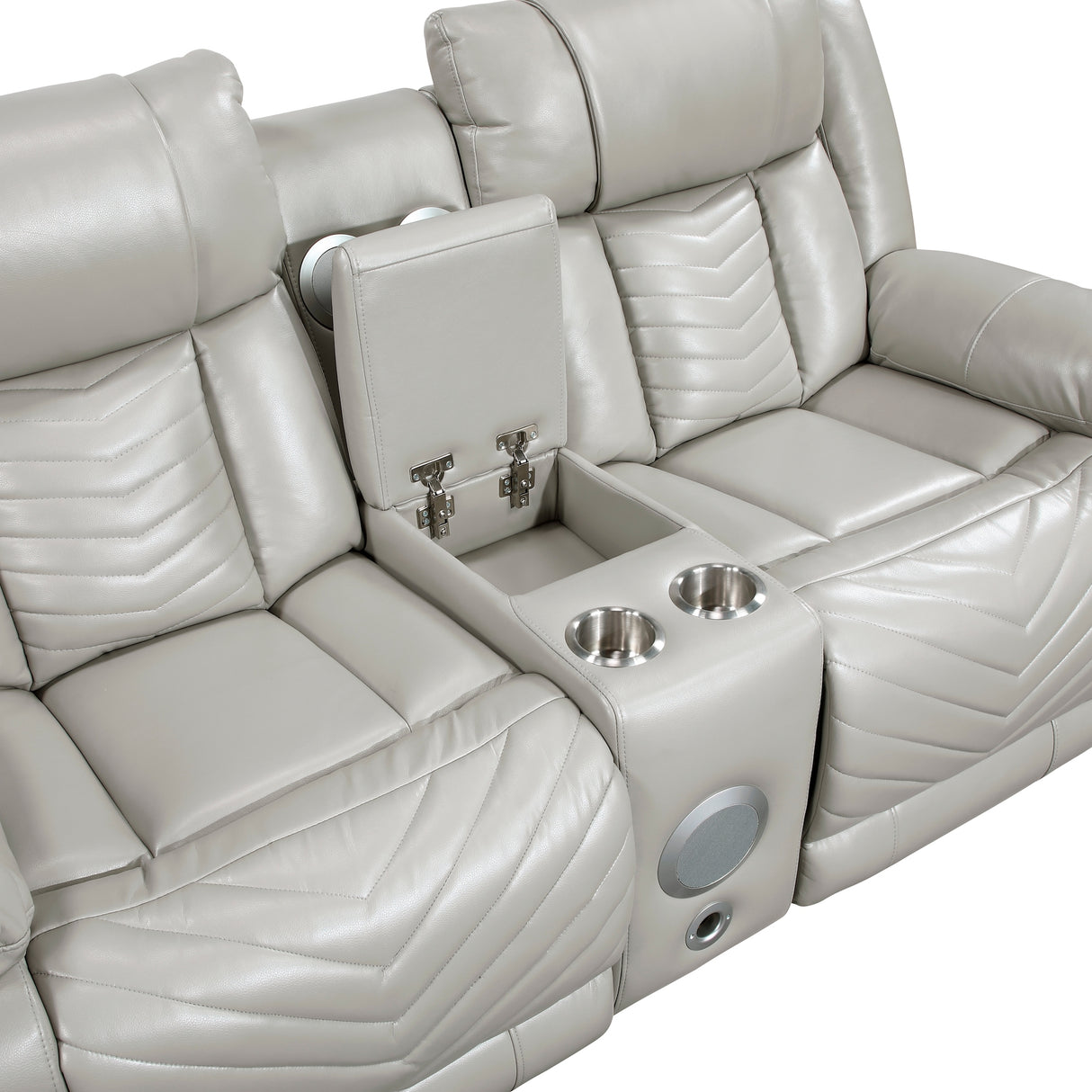 Open center console with stainless steel cup holders, hidden storage, and wireless speakers on gray power loveseat