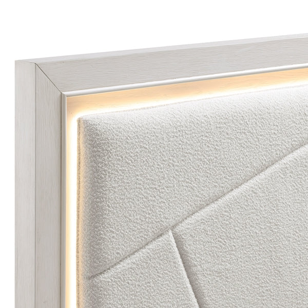 Close-up of a textured white wall with a silver frame.