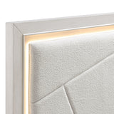 Close-up of a textured white wall with a silver frame.