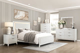Neatly arranged bedroom with white furniture including a bed, nightstands, and dresser.
