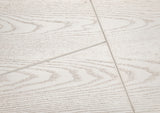 Close-up of a tiled floor with a light wood pattern