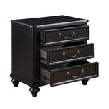 Black three-drawer nightstand with brass handles on a white background