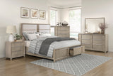 Beige bedroom set with bed, nightstands, dresser, and mirror in a well-lit room.