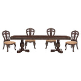 Dining table set with four ornate chairs on a white background