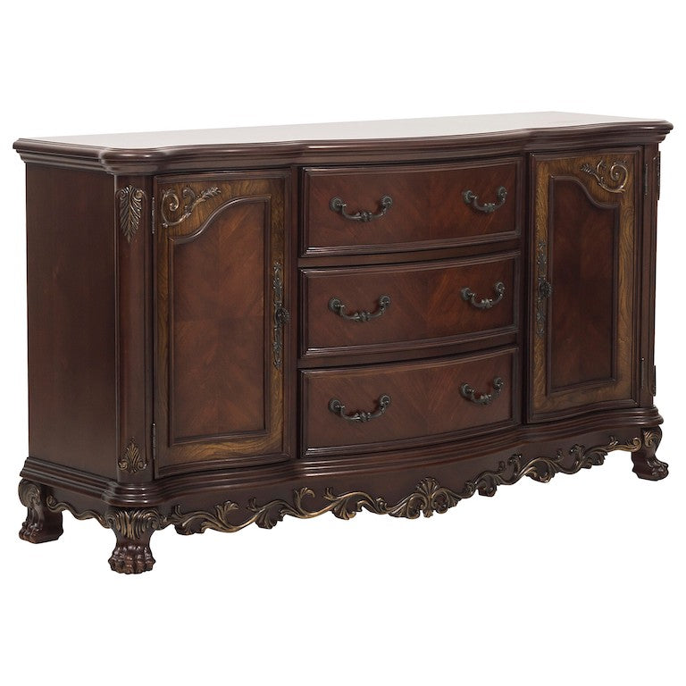 Wooden dresser with decorative carvings on a white background