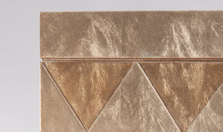 Close-up of a decorative tile with geometric pattern on a gray background