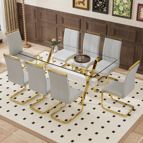 Table and chair set.Elegant Transparent Tempered Glass Dining Set - 71'x35.4' with 8 Light Gray PU Chairs with golden C-tube metal leg. - sold by Home Elegance USA