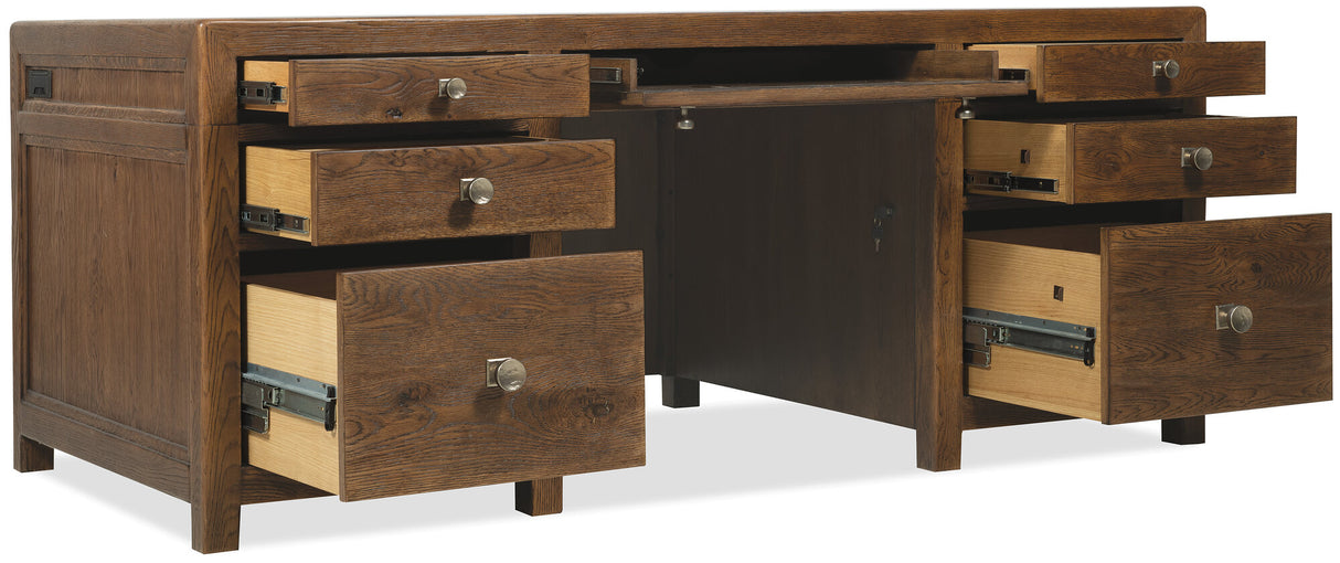 Wooden desk with multiple drawers on a white background