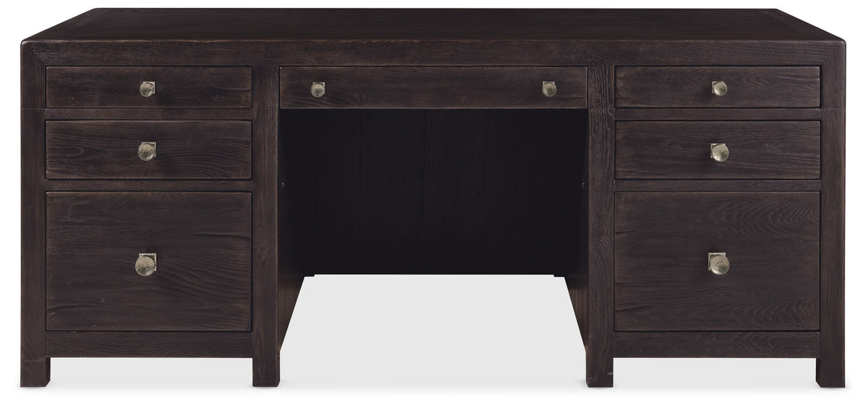 Dark wood desk with multiple drawers on a white background