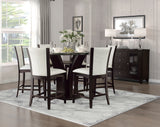Dining room with a dark wooden table and chairs with white cushions, a gray rug, and a sideboard.