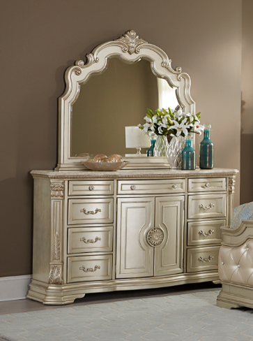 Decorative dresser with large mirror and decorative items on a neutral background