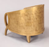 Gold metallic side table on a light gray background