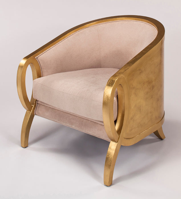 Chair with gold frame and beige cushion on a light gray background