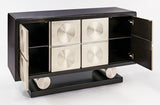 Modern black cabinet with open doors revealing metallic circular patterns on a white background