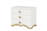Ivory dresser with gold accents on a white background