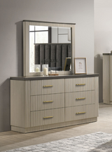 Dresser with mirror and decorative items in a room setting