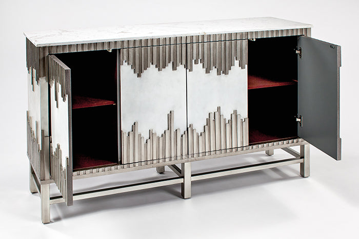 Modern metallic sideboard with abstract design on a white background