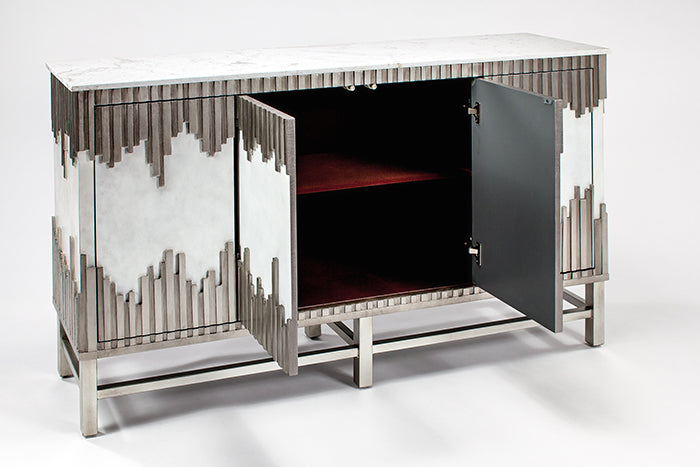 Decorative cabinet with metallic frame and glass panels on a white background