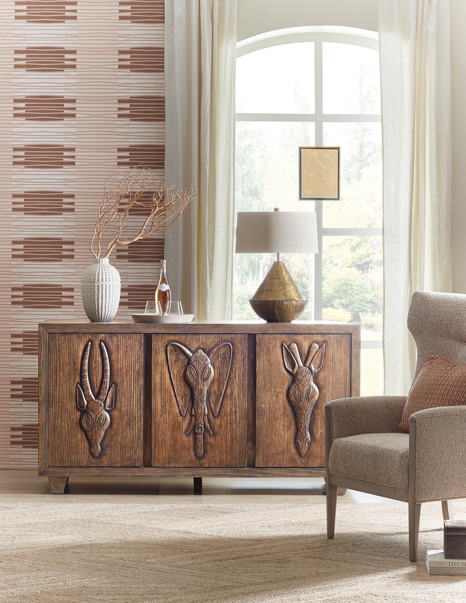 Wooden sideboard with animal head carvings in a room with a lamp and chair | Home Elegance USA