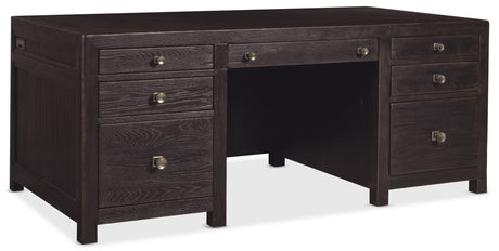 Dark wood L-shaped desk with multiple drawers on a white background