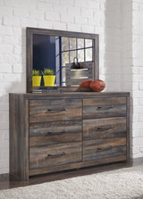 Wooden dresser with mirror against a white brick wall