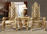Ornate gold throne chairs in a luxurious room with a fireplace and lamp.