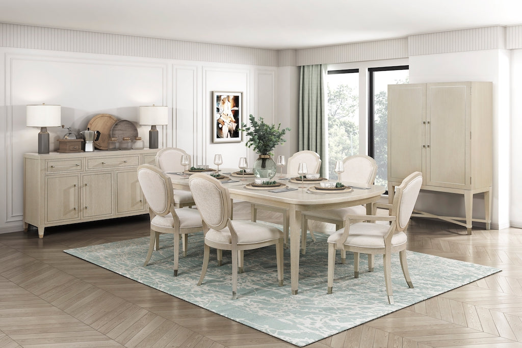 Dining room with beige furniture set on a light wooden floor.