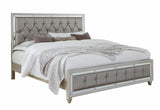 Silver tufted bed with white bedding and pillows on a white background