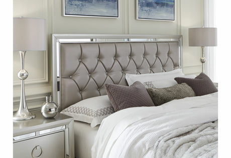 Neatly made bed with decorative pillows in a bedroom setting.