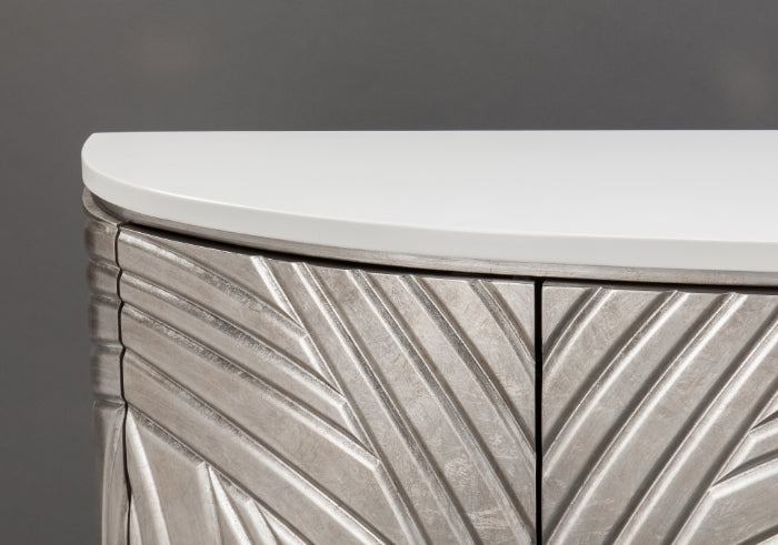 Close-up of a metallic side table with a white top