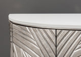 Close-up of a metallic side table with a white top