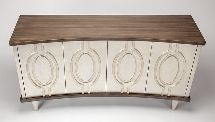 Decorative console table with wooden top and white base featuring circular patterns on a white background