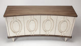Decorative console table with wooden top and white base featuring circular patterns on a white background