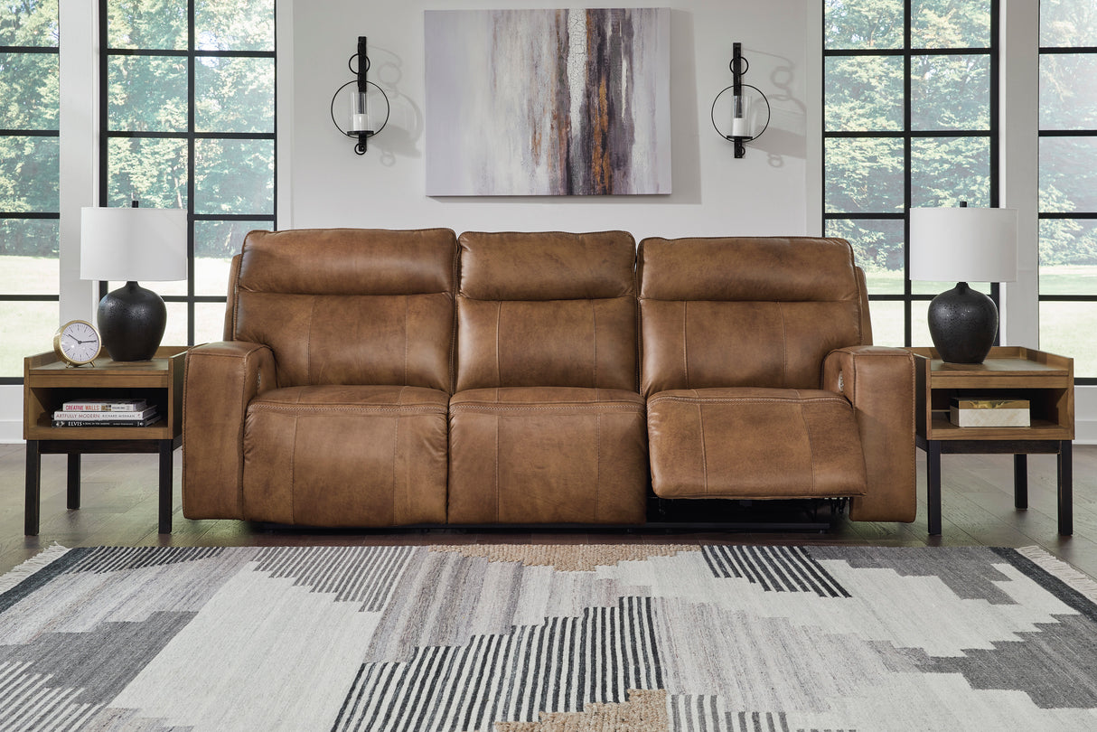 Game Plan Power Reclining Sofa with Adjustable Headrests in Caramel Leather by Ashley - Front room view