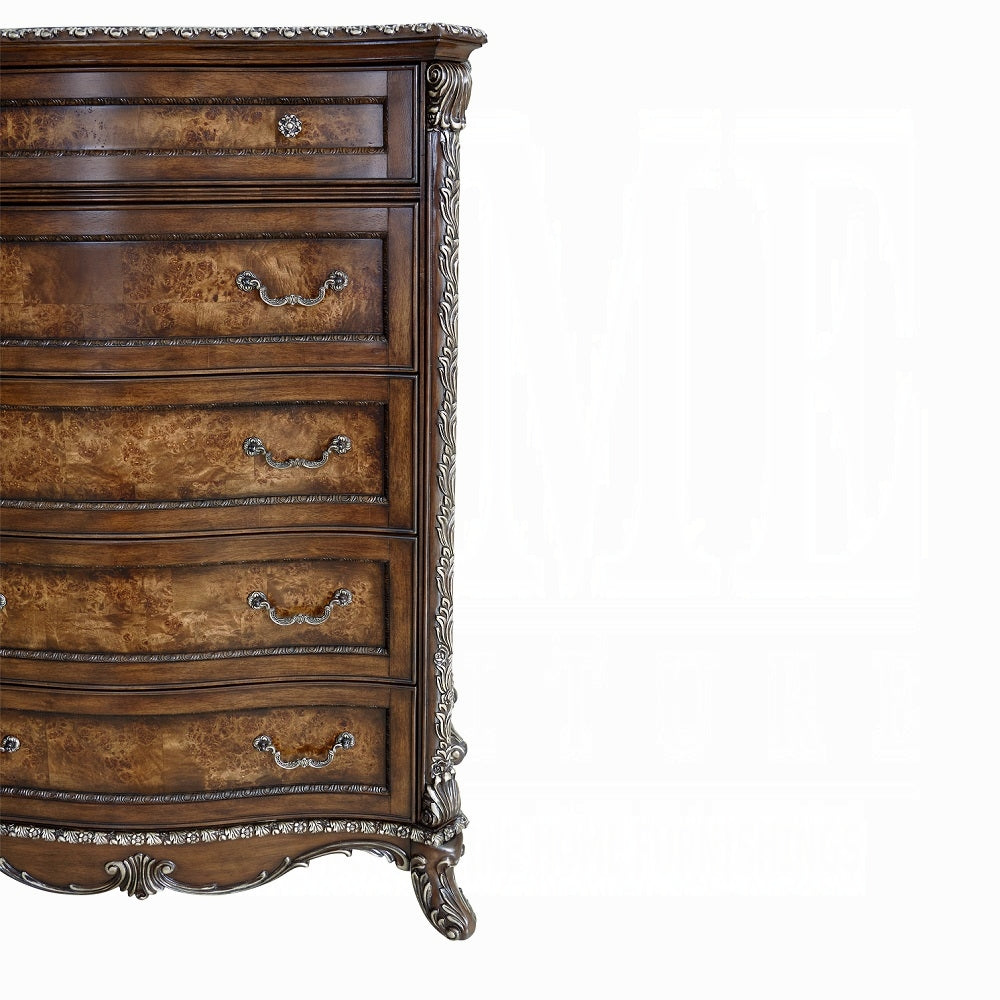 Vintage-style wooden dresser with intricate carvings on a white background